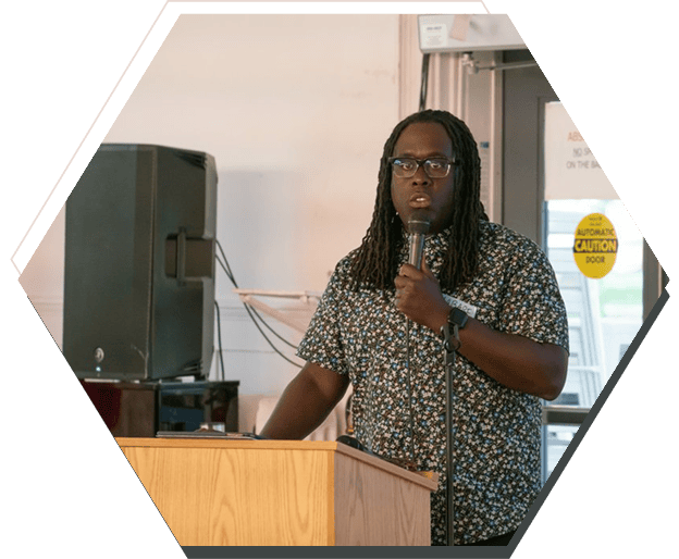 Person speaking at a podium with microphone.